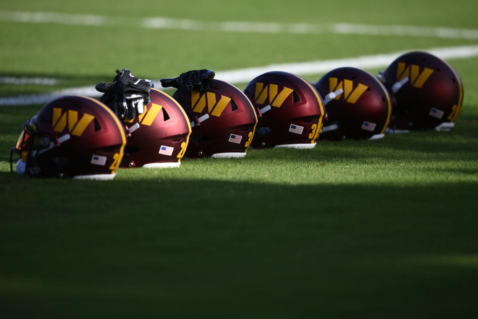 FILE- Washington Commanders helmets sit on the field during practice at the team's NFL football training facility, Monday, Aug. 1, 2022 in Ashburn, Va. The congressional investigation of the NFL's Washington Commanders will end when Republicans take over early next year. U.S. House Committee for Oversight and Reform ranking Republican Rep. James Comer issued a statement Thursday, Nov. 17, 2022, saying simply, ‘It’s over." (AP Photo/Nick Wass, File)