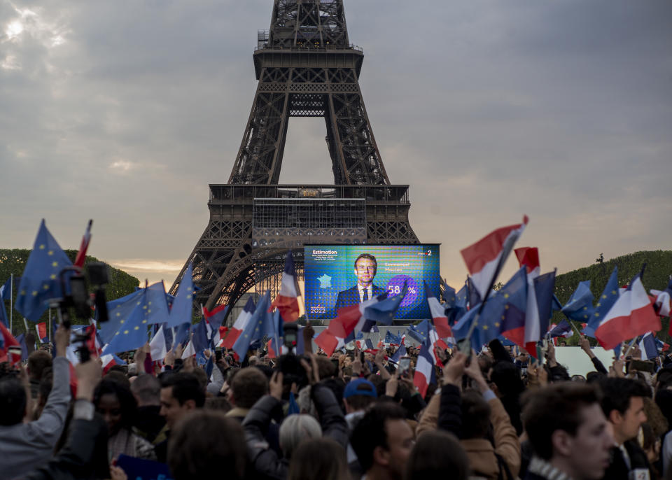 French President Emmanuel Macron celebrates with supporters in front of the Eiffel Tower Paris, France, Sunday, April 24, 2022. (AP Photo/Rafael Yaghobzadeh)