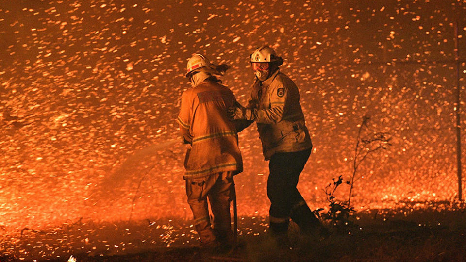 December 31, 2019 firefighters struggling against the strong wind in an effort to secure nearby houses from bushfires near the town of Nowra 