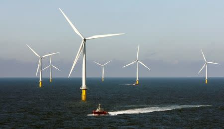 A crew boat passes through Horns Rev 2, a wind farm off the west coast of Denmark near Esbjerg September 15, 2009. REUTERS/Bob Strong/File Photo