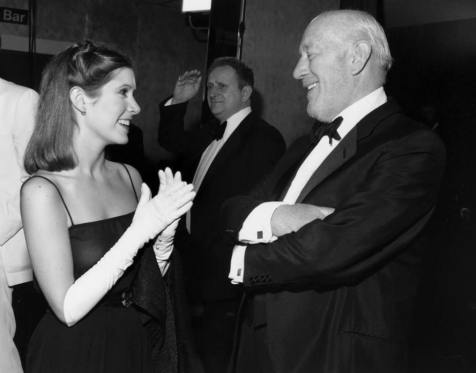 <p>Fisher chatted with costar Alec Guinness, who plays Obi-Wan Kenobi, at the royal premiere of <i>The Empire Strikes Back</i> in London on May 21, 1980. (Photo: Harry Myers/REX)</p>