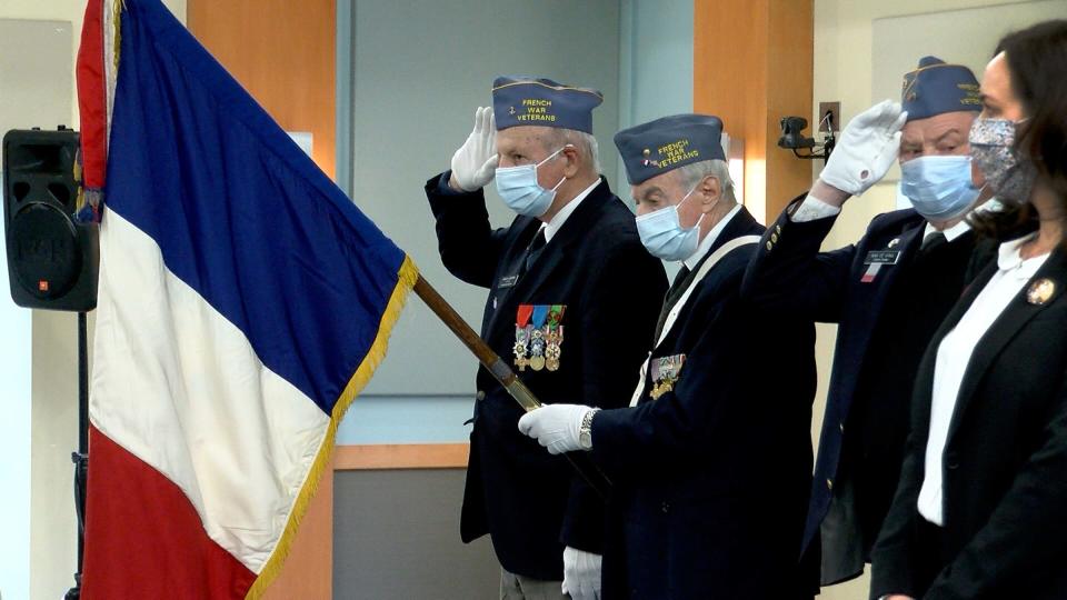 Members of the French War Veterans of New York City salute during the French National Anthem during a ceremony where  the insignia of the French Legion of Honor was preseneted to World War II veteran and retired United States Army Private First Class Edward L. Chan at Brookdale Community College Wednesday, April 6, 2022.  The presentation was made by French Consul General in New York Jérémie Robert .