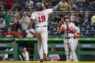 Washington Nationals' Josh Bell (19) celebrates as he approaches on-deck batter Yadiel Hernandez (29) after hitting a solo home run against the Pittsburgh Pirates during the sixth inning of a baseball game Friday, Sept. 10, 2021, in Pittsburgh. (AP Photo/Keith Srakocic)