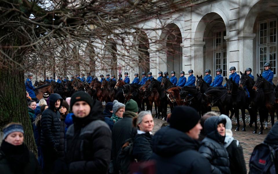 Crowds in Copenhagen watch the Danish Royal Guard rehearse for Sunday's transfer of power