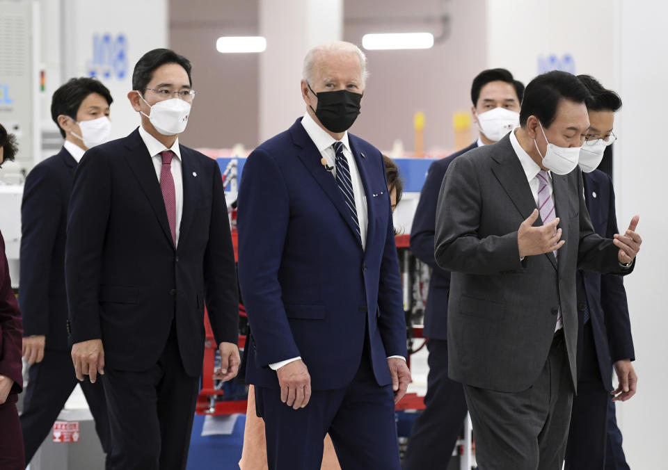 US President Joe Biden, cente, South Kroean President Yoon Suk-youl, right and Samsung Electronics Co. Vice Chairman Lee Jae-yong, second left, walk at the Samsung Electronic Pyeongtaek Campus, in Pyeongtaek, South Korea, Friday. May 20, 2022. (Kim Min-hee/Pool Photo via AP)