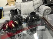 The various Godzilla-themes shoes by Japanese fashion designer Ryosuke Matsui, on a table also designed by Matsui, are shown during an interview with The Associated Press at his company office on the outskirts of Tokyo, Friday, March 22, 2024. Matsui described his joy at seeing “Godzilla Minus One” director Takashi Yamazaki and his Shirogumi special-effects team walk the red carpet and win the visual effects Oscar, all while wearing his shoes. (AP Photo/Yuri Kageyama)