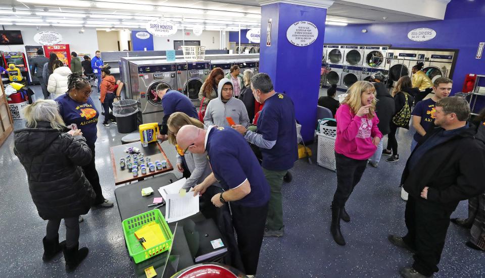 City representatives were on hand Thursday to help Akron residents wash their clothes during a free laundry event at Super Clean Laundromat. Akron Mayor Shammas Malik said he is looking into making the event a more regular occurrence.