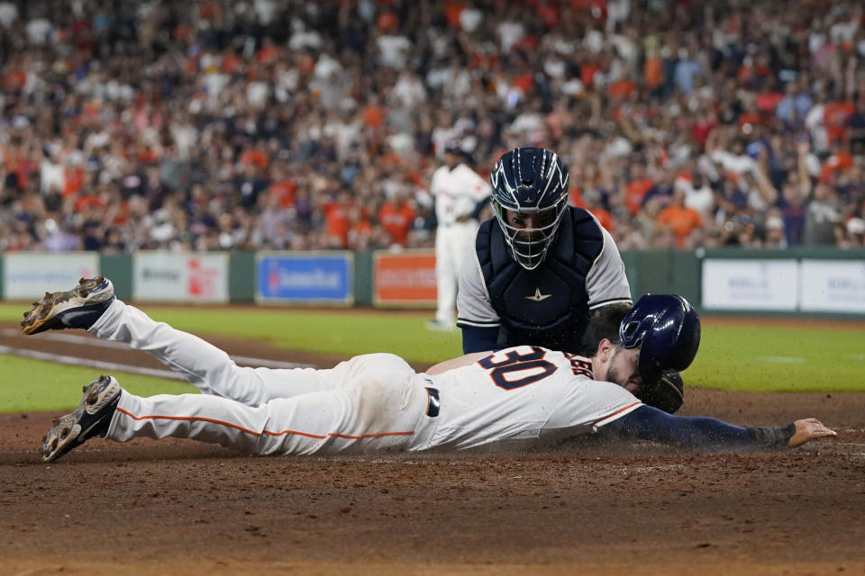 Houston Astros' Kyle Tucker (30) is tagged out by New York Yankees catcher Jose Trevino while trying to steal home plate during the third inning of a baseball game Thursday, June 30, 2022, in Houston. (AP Photo/David J. Phillip)