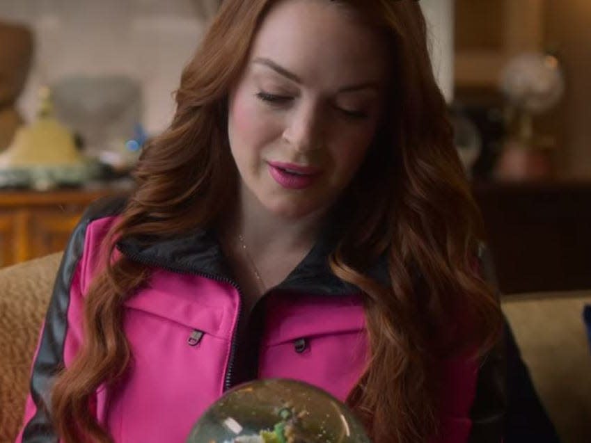 sierra looking at a snow globe in falling for christmas