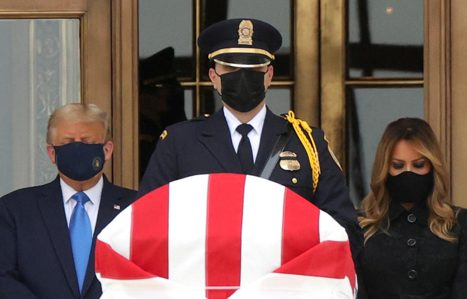 U.S. President Donald Trump and First Lady Melania Trump pay their respects to late Associate Justice Ruth Bader Ginsburg as her casket lies in repose at the top of the steps of the U.S. Supreme Court building in Washington, U.S., September 24, 2020. REUTERS/Jonathan Ernst     TPX IMAGES OF THE DAY