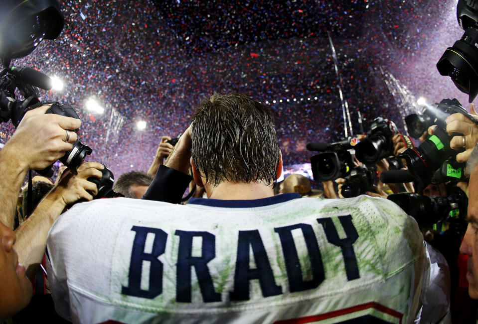 Tom Brady #12 of the New England Patriots is surrounded by the media after defeating the Seattle Seahawks 28-24 during Super Bowl XLIX at University of Phoenix Stadium on February 1, 2015 in Glendale, Arizona.