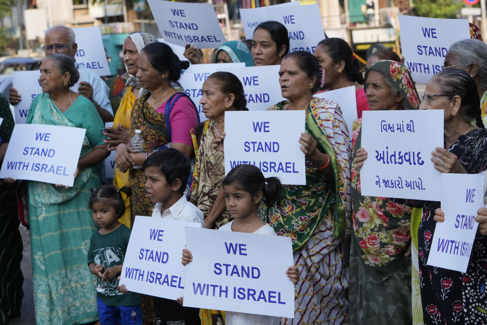 FILE-People hold placards in solidarity with Israel in Ahmedabad, India, Oct. 16, 2023. In Indian-controlled Kashmir, known for its vocal pro-Palestinian stance, authorities have barred any solidarity protests. Analysts say the new restrictions on speech reflect a shift in India’s foreign policy under the populist Prime Minister Narendra Modi away from its long-held support for the Palestinians. The government's shift aligns with widespread support for Israel among India’s Hindu nationalists who form a core vote bank for Modi and his Bharatiya Janata Party. (AP Photo/Ajit Solanki, File)