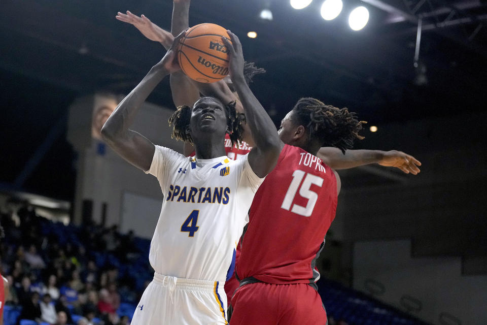 San Jose State center Adrame Diongue (4) drives to the basket against New Mexico forward JT Toppin (15) during the second half of an NCAA college basketball game Wednesday, Jan. 24, 2024, in San Jose, Calif. (AP Photo/Tony Avelar)
