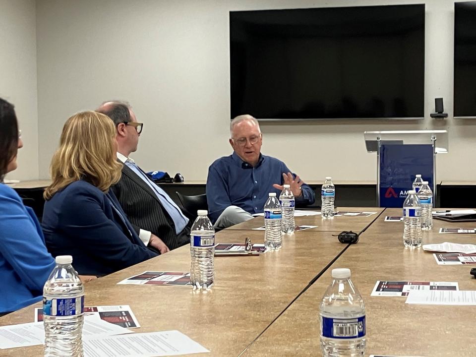 AmeriLux CEO Kurt Voss, right, talks with northeastern Wisconsin business leaders about civility and civic engagement during a Wisconsin Business Leaders for Democracy roundtable Thursday in De Pere.