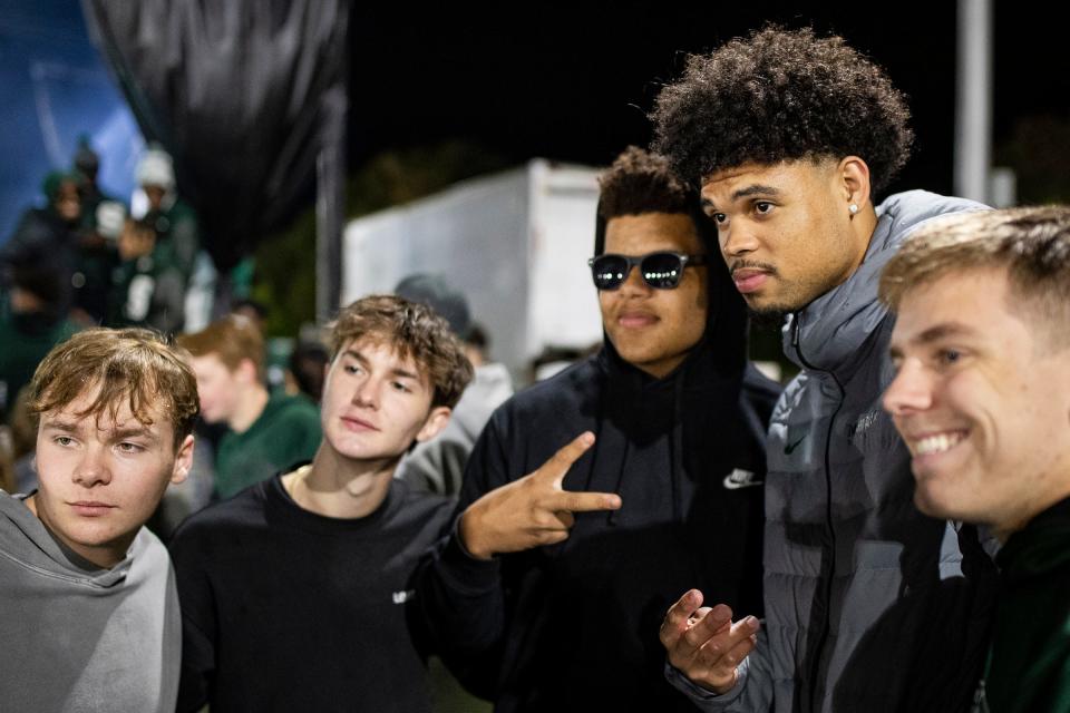 MSU player Malik Hall poses for a photo with fans during Izzone Campout at Munn Field near Breslin Center in East Lansing on Friday, Oct. 6, 2023.