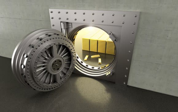 A bank vault with the door open showing the gold bars inside.