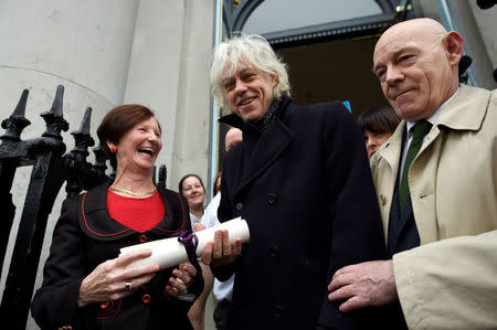 Bob Geldof arrives to return his 'Freedom of the City of Dublin' with local councillor Mannix Flynn and Oonagh Casey of Dublin's City Manager's office, after saying he could not continue to hold the honour with Myanmar leader Aung San Suu Kyi, in Dublin, Ireland, November 13, 2107. REUTERS/Clodagh Kilcoyne