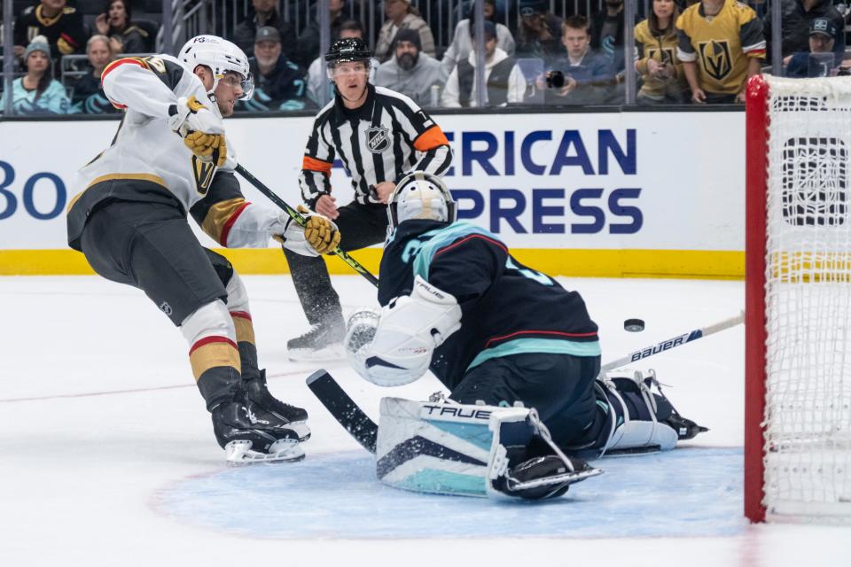 Golden Knights forward Ivan Barbashev (49) shoots against Kraken goalie Philipp Grubauer.