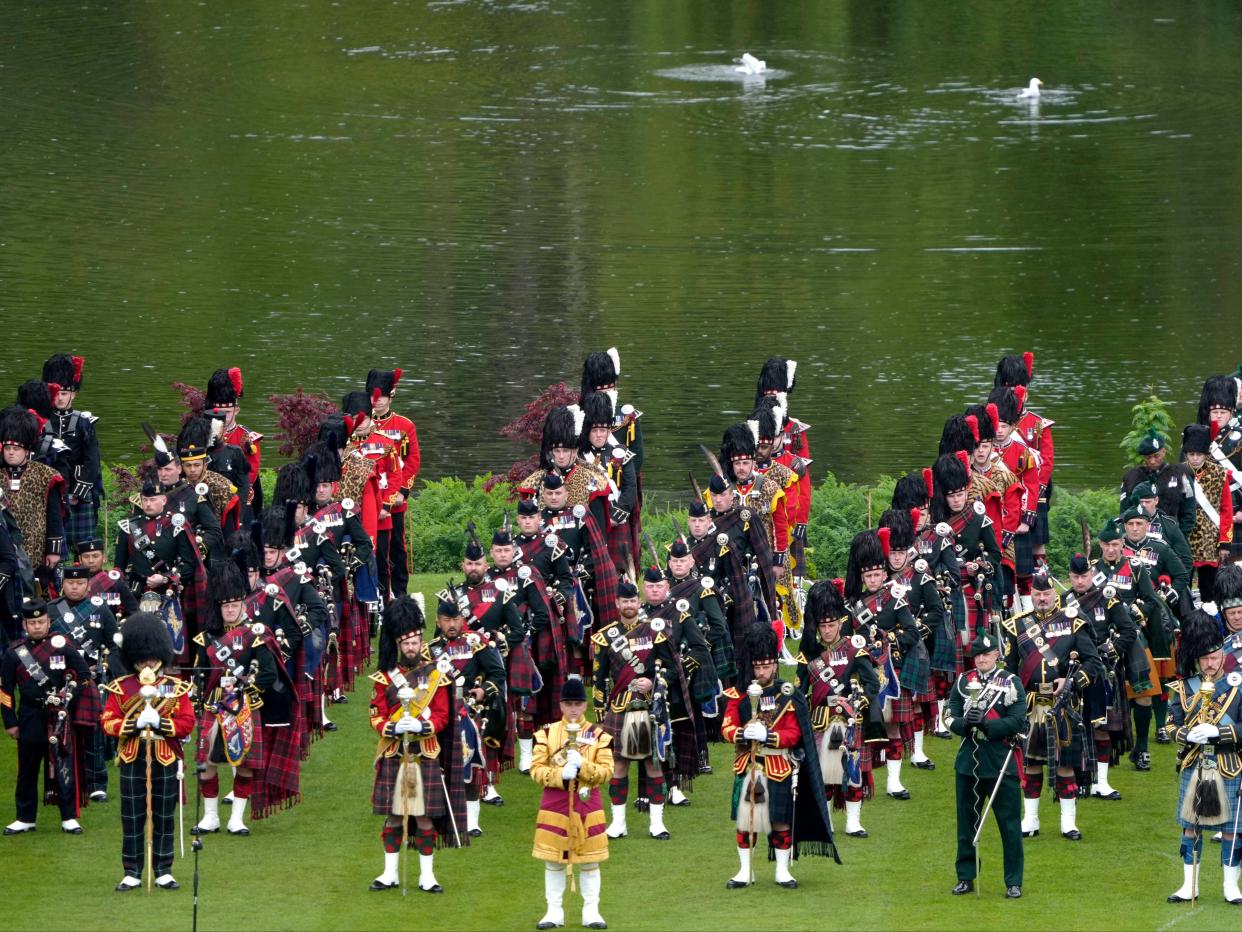 Members of the armed forces stand in formation on the lawn of Buckingham Palace (Getty Images)