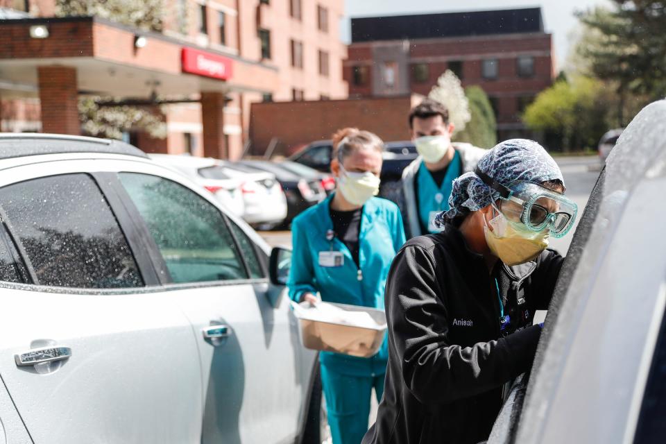 ER technicians test patients for Covid-19 outside of the emergency entrance of Beaumont Hospital in Grosse Pointe, Thursday, April 15, 2021.