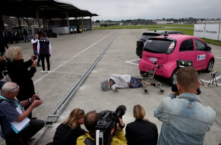 A crash test dummy with rollator is lying on the ground after collision with Mitsubishi i-MiEV electric car in a controlled crash test from insurer AXA, in Duebendorf