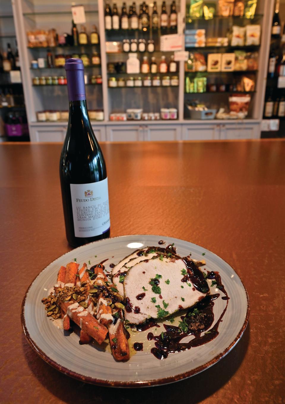 Herb encrusted pork loin with red wine fig reduction served with roasted carrots with maple yogurt and pumpkin seed granola.