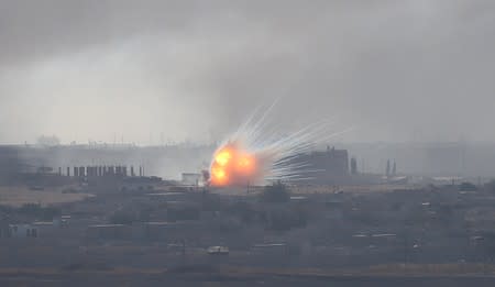 Explosion is seen over the Syrian town of Ras al-Ain as seen from the Turkish border town of Ceylanpinar