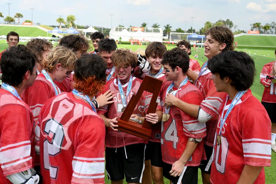 Ryan Kaplan holds the state championship trophy after Saint Andrew's faced The Bolles School in a boys 1A lacrosse state title matchup in Naples, Fla., Friday, May 6, 2023. (Photo/Chris Tilley)