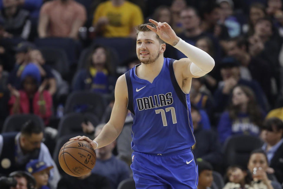 Dallas Mavericks forward Luka Doncic (77) dribbles upcourt against the Golden State Warriors during the first half of an NBA basketball game in San Francisco, Saturday, Dec. 28, 2019. (AP Photo/Jeff Chiu)