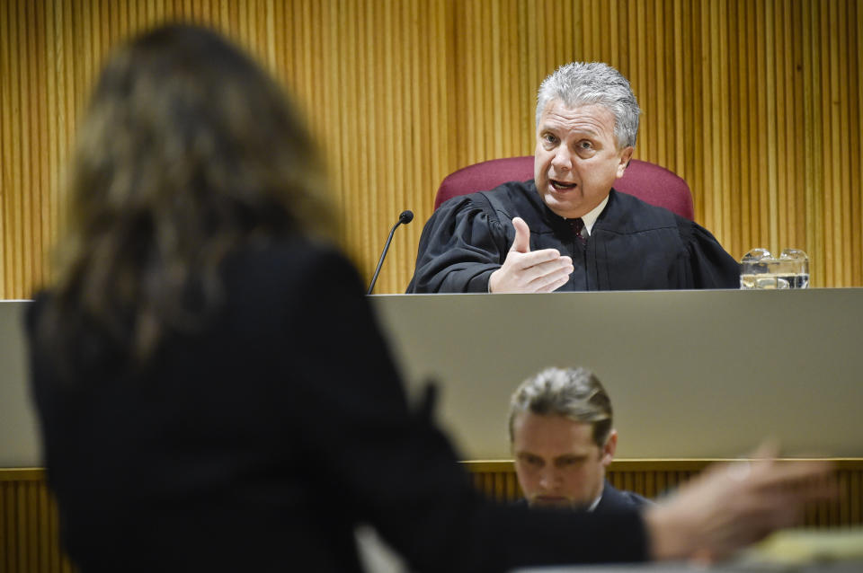 Montana Supreme Court Justice Dirk Sandefur, right, questions Maureen Lennon, attorney for the Montana Association of Counties, arguing on behalf of the Lincoln County Sheriff, on Wednesday, Jan. 8, 2020, in Helena, Mont., during arguments on whether local law enforcement officers have the authority to arrest people for alleged civil violations of federal immigration law. The ACLU, on behalf of Agustin Ramon, filed a lawsuit against Lincoln County in October 2018, after Ramon, a dual resident of Mexico and France, was arrested for stealing prescription medication from a neighbor's house in Eureka Court. (Thom Bridge/Independent Record via AP)