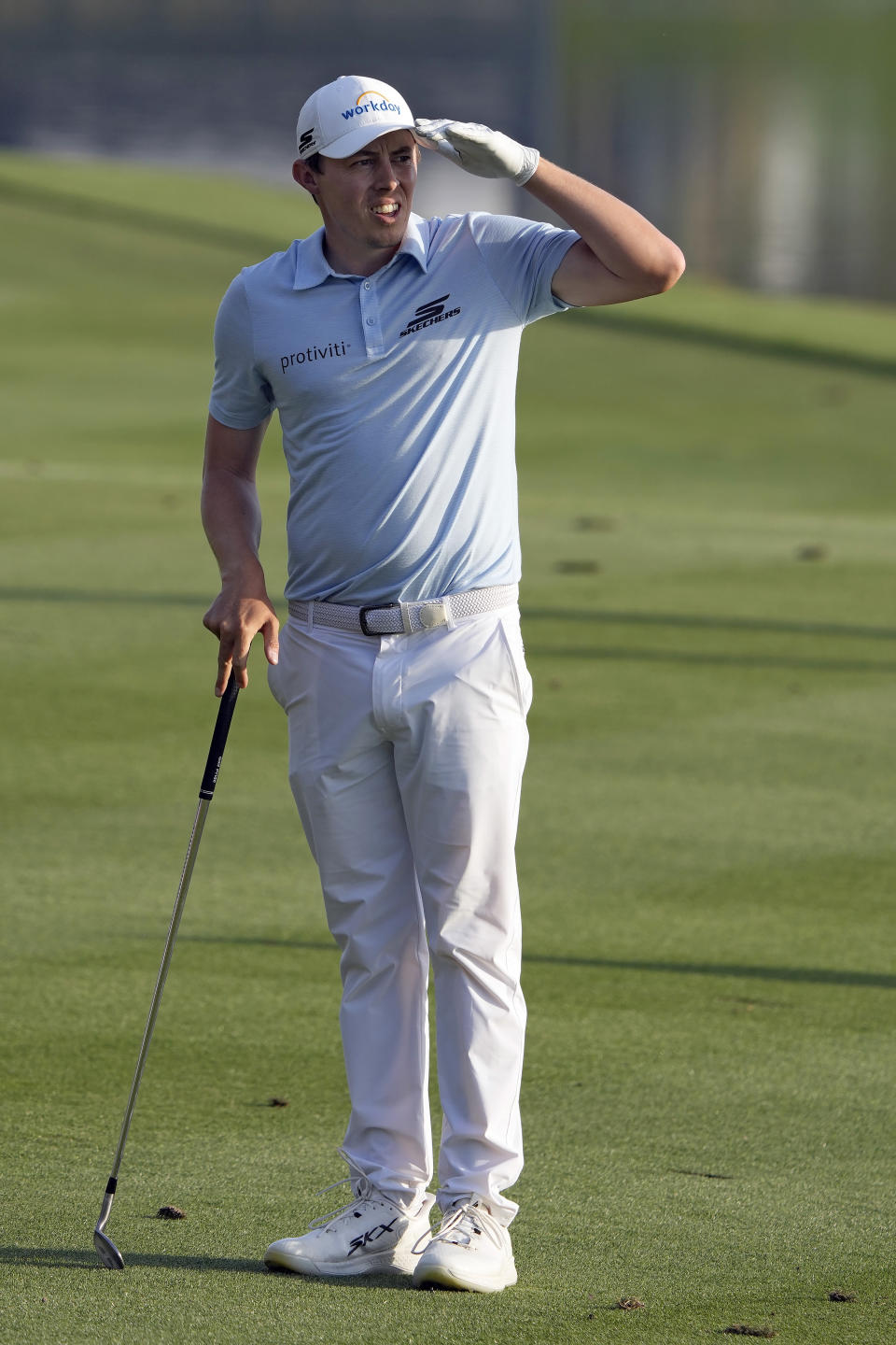 Matt Fitzpatrick, of England, uses his hand to block the sun while watching his shot on the 18th fairway during the first round of The Players Championship golf tournament Thursday, March 14, 2024, in Ponte Vedra Beach, Fla. (AP Photo/Lynne Sladky)