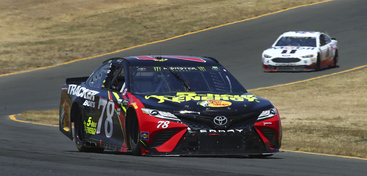 Martin Truex Jr. (78) leads Kevin Harvick (4) through a turn during a NASCAR Sprint Cup Series auto race Sunday, June 24, 2018, in Sonoma, Calif. (AP Photo/Ben Margot)