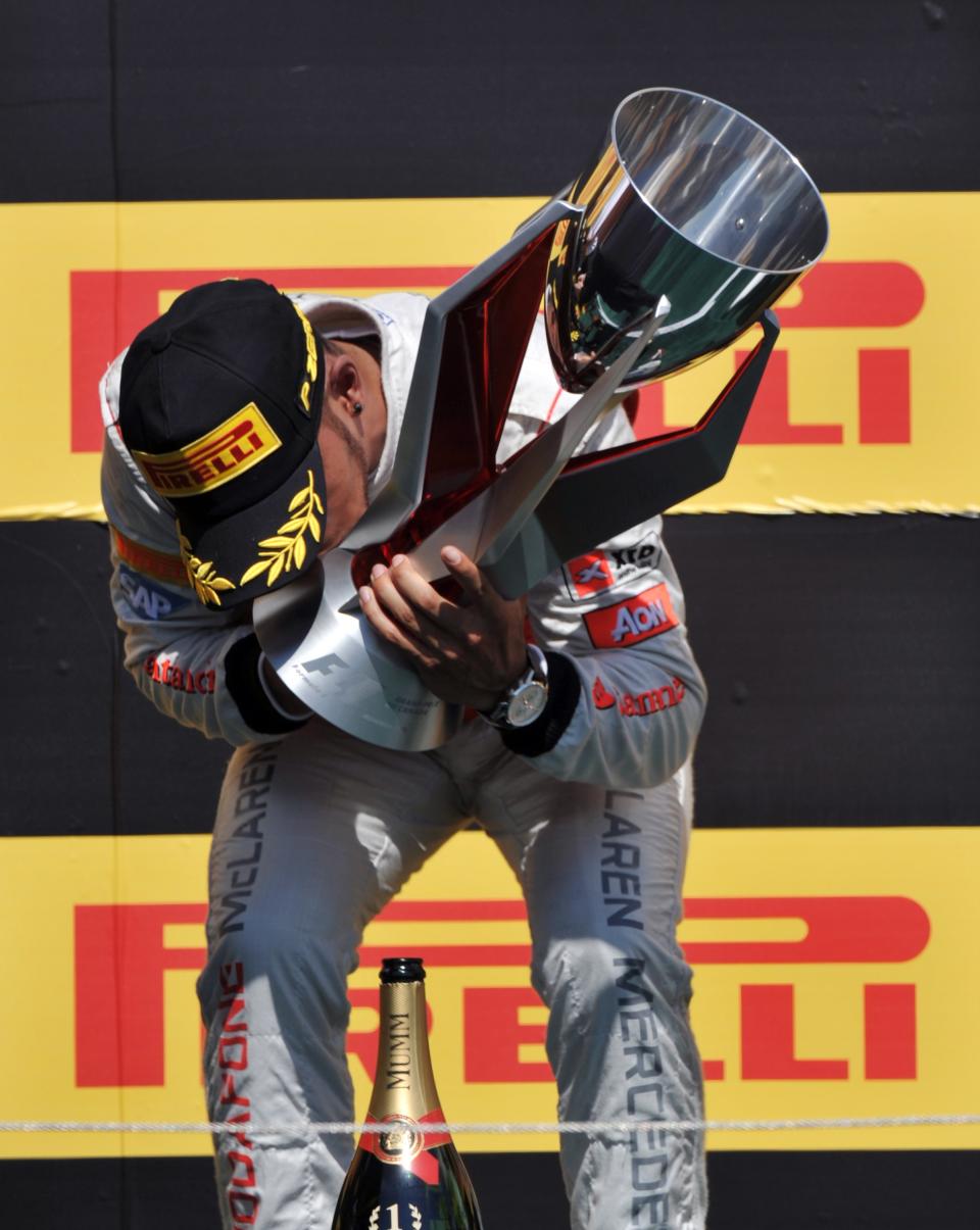 McLaren Mercedes driver Lewis Hamilton of Britain kisses the trophy after winning the Canadian Formula One Grand Prix on June 10, 2012 at the Circuit Gilles Villeneuve in Montreal. AFP PHOTO/Stan HONDASTAN HONDA/AFP/GettyImages