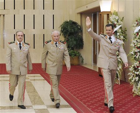 Syria's President Bashar al-Assad (R) waves as he arrives with Syrian Defense Minister General Ali Habib (C) and Chief of Staff General Dawoud Rajha to attend a dinner to honour army officers on the 65th Army Foundation anniversary in Damascus in this August 1, 2010 file photo. Former Syrian Defence Minister General Ali Habib, a prominent member of President Bashar al-Assad's Alawite sect, has defected and is now in Turkey, a senior member of the opposition Syrian National Coalition told Reuters on September 4, 2013. REUTERS/SANA/Handout