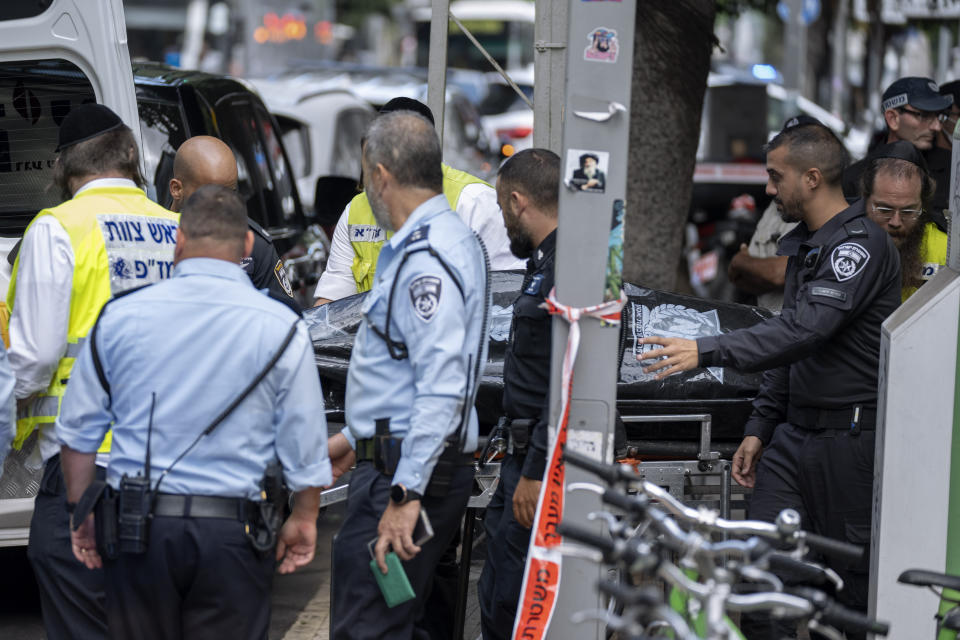 Israeli police remove the body of Palestinian Musa Sarsour after he allegedly killed an 84-year-old Israeli woman and then hung himself, in Tel Aviv, Israel, Wednesday, Sept. 21, 2022. Israeli police said Sarsour was found hung in central Tel Aviv after an overnight manhunt, hours after he was said to have struck and killed the woman with a heavy object in a Holon, near Tel Aviv. (AP Photo/Oded Balilty)