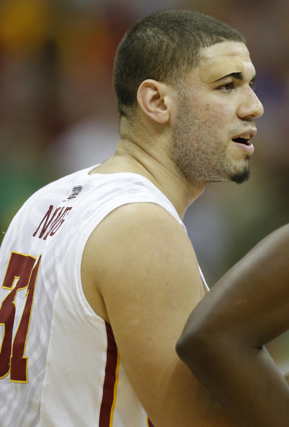 Iowa State forward Georges Niang talks with teammates during a timeout in the first half of an NCAA college basketball game against Baylor in the final of the Big 12 Conference men's tournament in Kansas City, Mo., Saturday, March 15, 2014. Niang sports a bandage over his right eye covering an injury received in a semifinal. (AP Photo/Orlin Wagner)