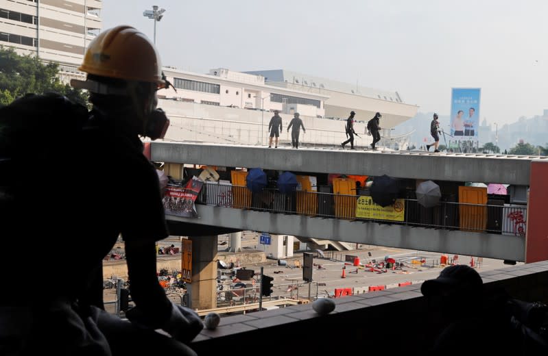 Protesters walk on a bridge that runs over the entrance to the Cross Harbour Tunnel in Hong Kong