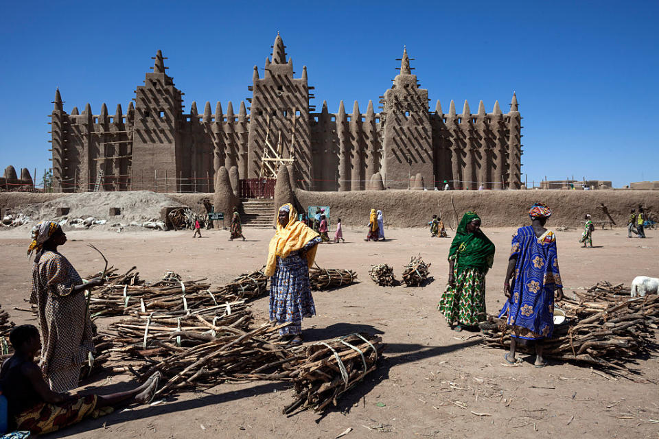 In front of the Great Mosque of Djenne on January 22, 2010 in Djenne, Mopti region, Mali. The Mosque is located in the old town of Djenné, World Heritage Site by UNESCO, on the flood plain of the Bani River | Andrea Borgarello—Getty Images
