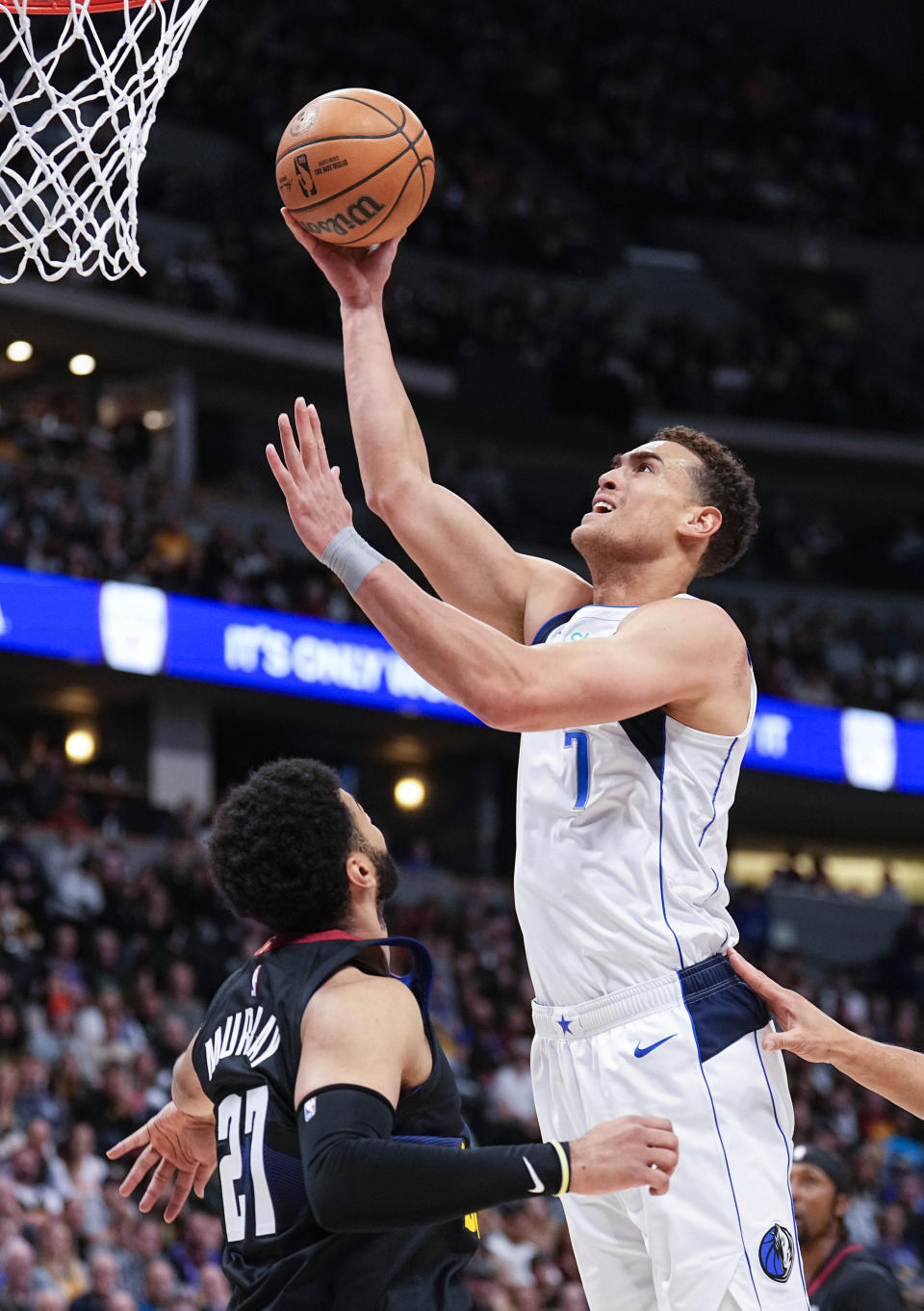 Dallas Mavericks center Dwight Powell (7) shoots against Denver Nuggets guard Jamal Murray (27) during the first quarter of an NBA basketball game Monday, Dec. 18, 2023, in Denver. (AP Photo/Jack Dempsey)