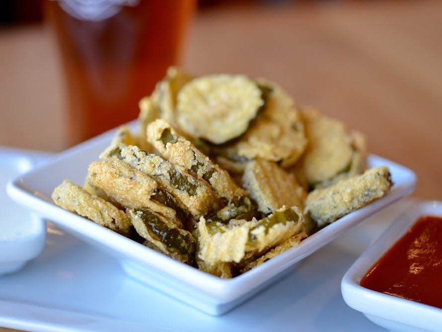 Fried pickle chips in a white bowl