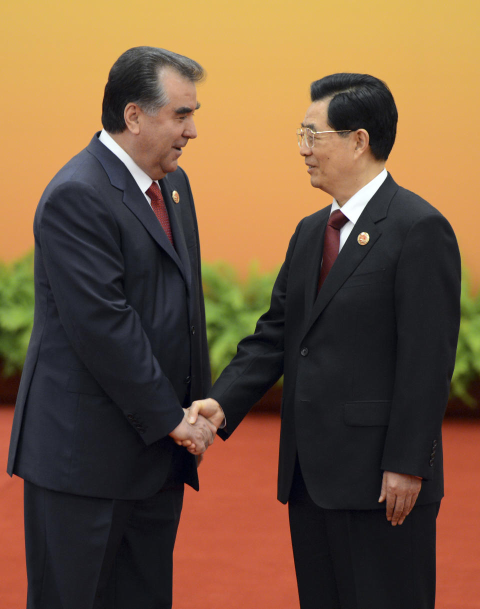 Chinese President Hu Jintao, right, shakes hands with Tajikistan's President Emomali Rakhmon at the Shanghai Cooperation Organization (SCO) summit in the Great Hall of the People in Beijing, China Thursday, June 7, 2012. (AP Photo/Mark Ralston, Pool)