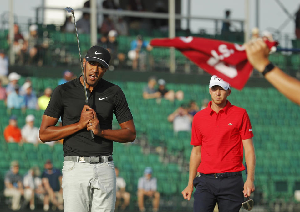 FILE - In this June 17, 2018, file photo, Tony Finau, left, reacts after a putt on the 16th green during the final round of the U.S. Open Golf Championship, in Southampton, N.Y. Finau has no problem with Nike's new campaign with Colin Kaepernick. (AP Photo/Carolyn Kaster, File)