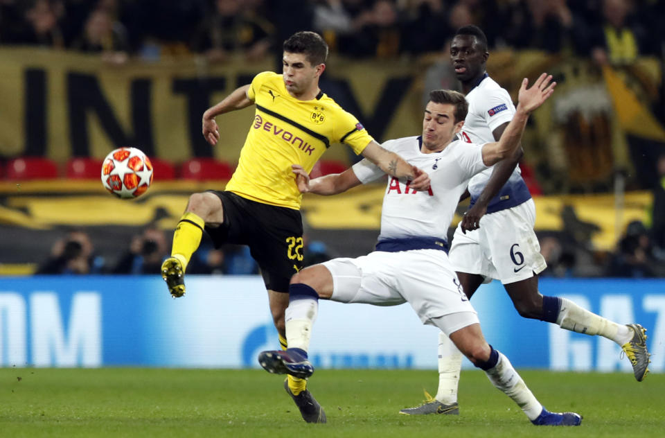 Tottenham midfielder Harry Winks fights for the ball with Dortmund midfielder Christian Pulisic, left, during the Champions League round of 16, first leg, soccer match between Tottenham Hotspur and Borussia Dortmund at Wembley stadium in London, Wednesday, Feb. 13, 2019. (AP Photo/Alastair Grant)