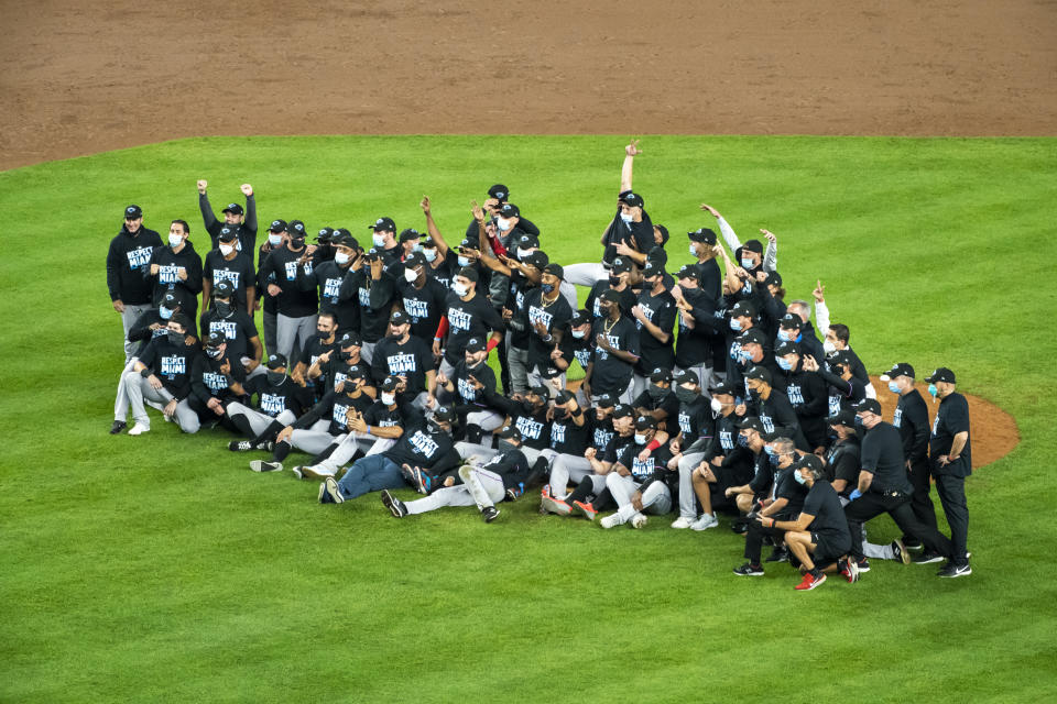 The Miami Marlins gather for a photograph on the pitcher's mound after clinching a playoff berth when they won in the 10th inning of a baseball game against the New York Yankees at Yankee Stadium, Friday, Sept. 25, 2020, in New York. (AP Photo/Corey Sipkin)