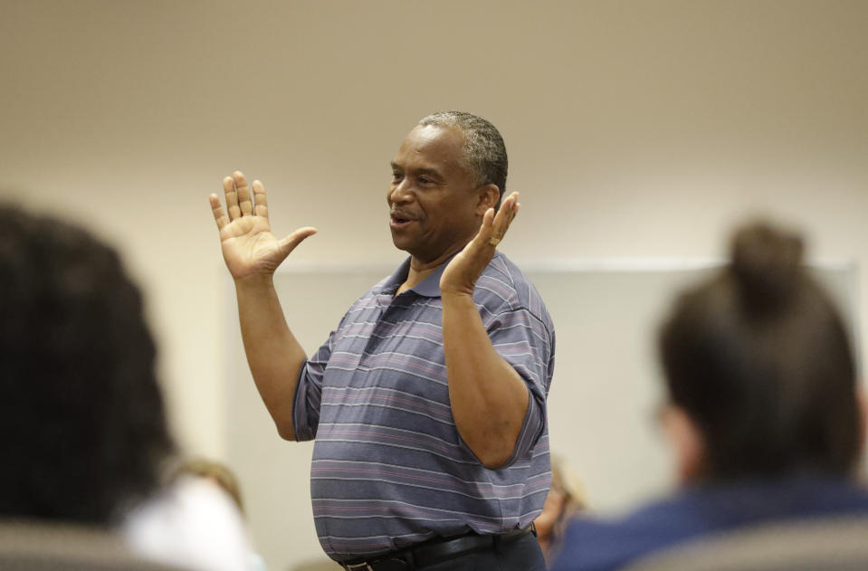 In this, Wednesday, Feb. 12, 2020 photo, Vincent Keeys, standing, president of the NAACP in Collier County, talks to a group of nonprofit leaders and government agencies about the Census undercount in 2010, in Immokalee, Fla. "In 2010, we had a lot of money on the table that was just lost and didn't come to the community. It is so critically important," said Keeys. Small, poor and largely Latino communities around the U.S. historically have been undercounted, an analysis by The Associated Press shows, posing challenges for Census workers in a tally that's supposed to ensure federal dollars get to communities needing them most. (AP Photo/Wilfredo Lee)