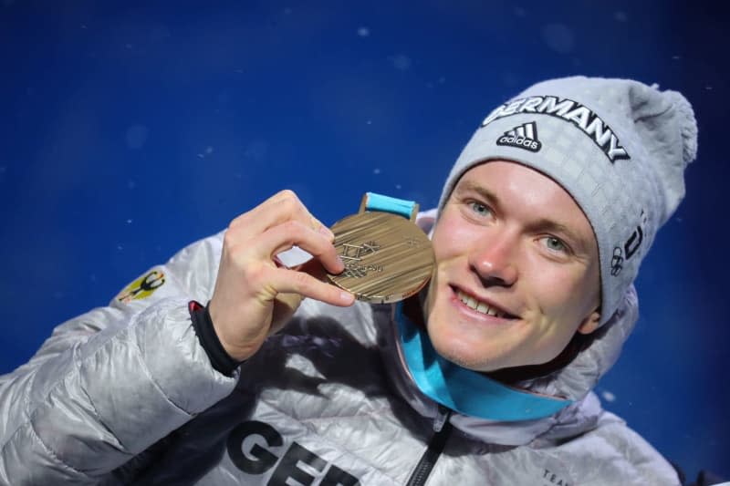 Germany's Benedikt Doll celebrates his bronze medal on the podium at the medal ceremony after the men's biathlon pursuit at the PyeongChang 2018 Olympic Games. Former biathlon world champion Benedikt Doll of Germany has said on Friday he will end his career after 12 years in the World Cup at the end of the season. Michael Kappeler/dpa