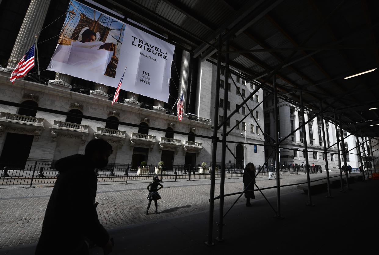 People walk past the New York Stock Exchange (NYSE) at Wall Street on February 17, 2021 in New York City. (Photo by Angela Weiss / AFP) (Photo by ANGELA WEISS/AFP via Getty Images)