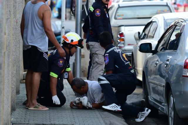 Rescue workers attend to an injured man after a small bomb exploded in Thailand's Hua Hin on August 12