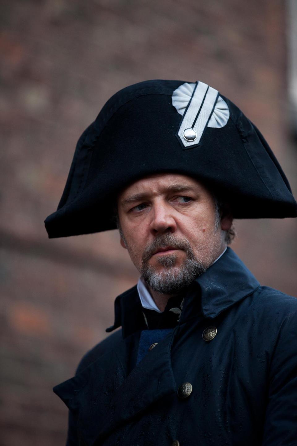 This undated publicity image provided by Universal Pictures shows Russell Crowe as Javert, center, in a scene from the motion-picture adaptation of "Les Misérables,” directed by Tom Hooper. A familiar lineup of Hollywood awards contenders are expected among Golden Globe nominations coming out Thursday morning, Dec. 13, 2012, whose prospects include past Oscar winners Daniel Day-Lewis, Helen Mirren, Robert De Niro and Sally Field. Other Oscar recipients may be nominated, such as Mirren and Anthony Hopkins for “Hitchcock,” Philip Seymour Hoffman for “The Master,” Helen Hunt for “The Sessions,” Marion Cotillard for “Rust and Bone,” Russell Crowe for “Les Miserables” and Alan Arkin for “Argo.” (AP Photo/Universal Pictures, Laurie Sparham)