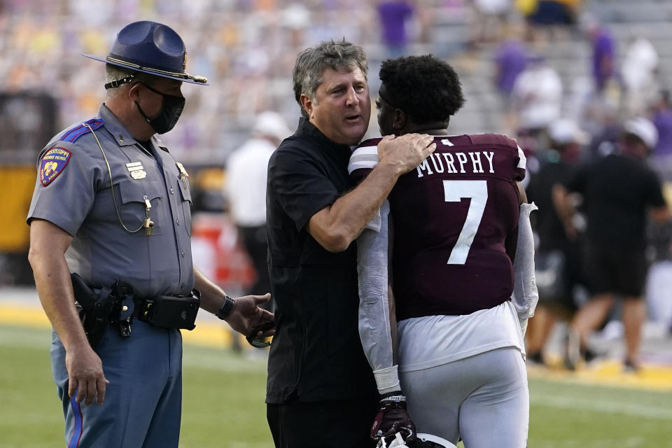 Mississippi State head coach Mike Leach hugs safety Marcus Murphy (7) after an NCAA college football game against LSU in Baton Rouge, La., Saturday, Sept. 26, 2020. Mississippi State won 44-34. (AP Photo/Gerald Herbert)
